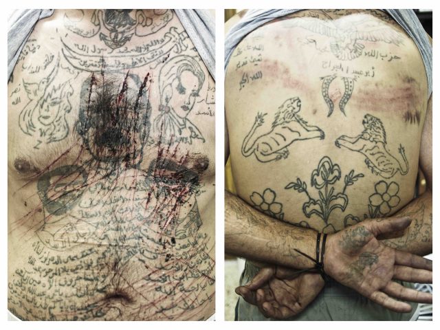 Marae, Aleppo Province, Syria. July, 2012. The chest of Zacharia Gazmouth, a suspected Shabiha prisoner, his body covered in  pro-Assad tatoos, is a prisoner at a makeshift jail in the rebel-held town of Marae, Aleppo Province.