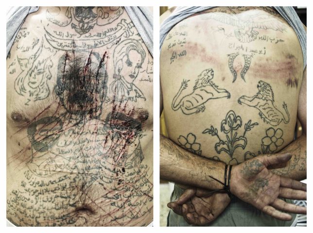 Marae, Aleppo Province, Syria. July, 2012. The chest of Zacharia Gazmouth, a suspected Shabiha prisoner, his body covered in  pro-Assad tatoos, is a prisoner at a makeshift jail in the rebel-held town of Marae, Aleppo Province.