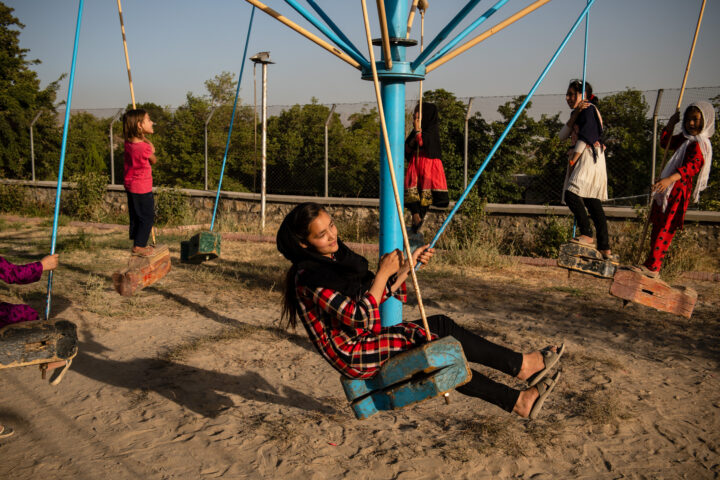 KABUL | AFGHANISTAN | 8/5/18 | Zarina (14) plays with her friends and neighbors at marastoon's playground. Zarina is often quiet and doesn't express her feelings but she has enormous amount of rage against her mother. Qalam Nesa, who has survived three attacks as a child, that she recalls as “airplanes dropping bombs”, suffers from an undiagnosed, yet, extreme mental disorder. She was first married off when she was 13 and has been married twice more since then. She has good days and bad days. On her good days, she’s active, sings, dances, sews and goes out. On her bad days, she sits in a corner and cries non-stop, starts a fight with other women or her kids at the house or the staff at marastoon.