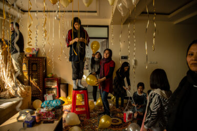 KABUL | KABUL | AFGHANISTAN | 2/6/21 | Foroohar (19) decorates their living room in preparation for a surprise birthday party for her younger sister, Farangis. The family has arrange for friends and relatives, all women, to come together before Farangis make an entrance.
In the last 20 years, an entire generation of largely urban Afghans have grown up with all the basic liberties that the Taliban had erased during the rulings in the 90s. Now they are gripped by fear that all those rights they've gained could be at risk.