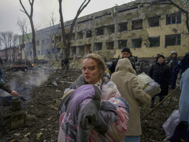 Marianna Vishegirskaya stands outside a maternity hospital that was damaged by shelling in Mariupol, Ukraine, Wednesday, March 9, 2022. Vishegirskaya survived the shelling and later gave birth to a girl in another hospital in Mariupol. (AP Photo/Mstyslav Chernov)