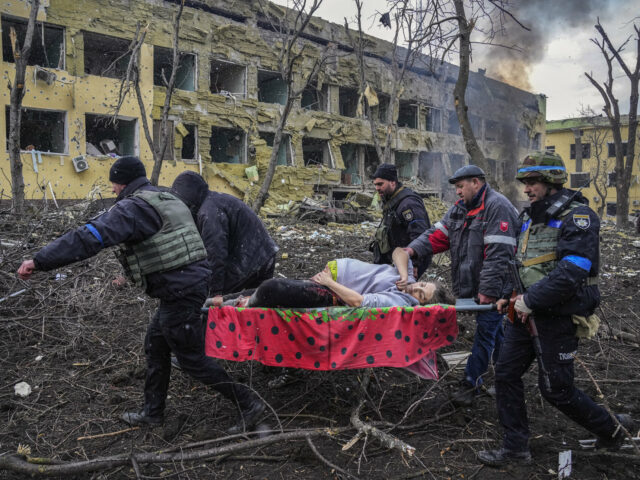 Ukrainian emergency employees and volunteers carry an injured pregnant woman from a maternity hospital that was damaged by shelling in Mariupol, Ukraine, March 9, 2022. The woman and her baby died after Russia bombed the maternity hospital where she was meant to give birth. (AP Photo/Evgeniy Maloletka, File)