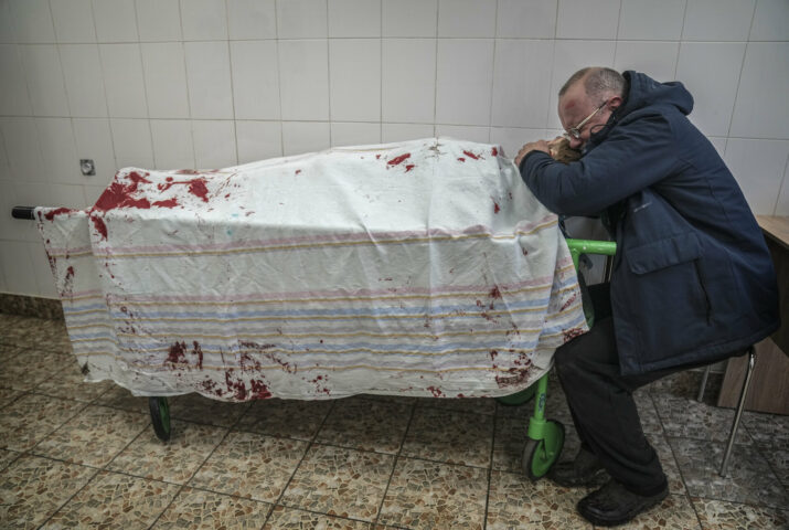 Serhii, father of teenager Iliya, cries on his son's lifeless body lying on a stretcher at a maternity hospital converted into a medical ward in Mariupol, Ukraine, Wednesday, March 2, 2022. (AP Photo/Evgeniy Maloletka)