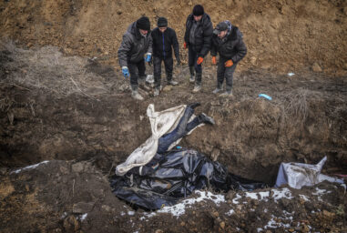 Dead bodies are put into a mass grave on the outskirts of Mariupol, Ukraine, Wednesday, March 9, 2022 as people cannot bury their dead because of the heavy shelling by Russian forces. (AP Photo/Evgeniy Maloletka)