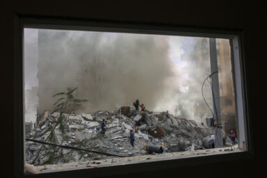 NYTGAZA Palestinian citizens inspect a destroyed building and civil defense men try to control some fires that broke out after the Israeli warplanes bombed downtown Gaza City.