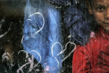 A refugee boy looks through the window of his home inside a refugee centre near Bosanski Petrovac May 18, 2007. More than 200 refugees from the troubled Serbian province of Kosovo, mostly Roma people, are still waiting for Bosnian citizenship or a transfer to third countries. Their refugee status will expire soon, after almost a decade spent as refugees in Bosnia. Damir Sagolj