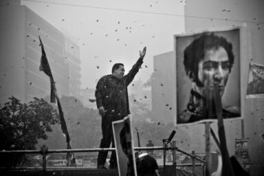 Caracas - Venezuela. Venezuelan President Hugo Chavez, candidate to reelection, appears on stage at the presidential campaign closing day. Supporters waited for many hours under heavy rain thinking Mr Chavez's sensitive health could keep him away from the activity. Mr Chavez finally made it to the meeting to ask for support for the upcoming elections that he finally won.