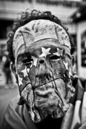 Caracas - Venezuela. An student is seen with a mask with venezuelan flag pierced by a bullet,  in Caracas south east at a march against Nicolas Maduro government calling for security and protesting against high inflation and violence rates.