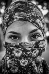 A young female protestor stands for a portrait while clashes take place in Caracas east side after a march of opposition was diverted by police forces at different points of the city.