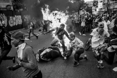 Orlando Figueroa, 21 years old, runs after been set on fire by a group of protestors oppossing Nicolas Maduro government in the area of Altamira in Caracas. 2 weeks later the young man died of a cardiopulmonar failure. Some versions said the young man was caught pick pocketing at the demonstration, others say the man was accussed of being a supporter of the government, another version pointed that the man was attacked by somebody for a personal problem and that person later accused him of being robbering. This act has been one of the most brutal and senseless act in the more than 80 days of political unrest in Venezuela.