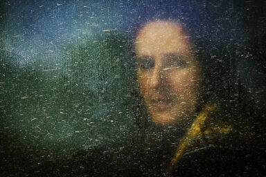 A Bosnian Muslim woman looks through the window of a bus as she arrives at Potocari in the wartime U.N. protected enclave of Srebrenica July 11, 2001. Thousands of Bosnian Muslims returned to the site of the Srebrenica massacre to launch a memorial on the sixth anniversary of what is seen as the worst war crime in Europe since World War Two.